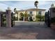 A stately residence, showcased through an ornate gate, features lush landscaping and an inviting facade at 7261 Obannon Dr, Las Vegas, NV 89117