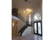 A soaring two-story foyer features a staircase, large arched window, and decorative glass front doors at 7261 Obannon Dr, Las Vegas, NV 89117