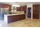 Chef's kitchen with custom cabinets, stainless steel appliances, and marble island with a built-in sink at 7261 Obannon Dr, Las Vegas, NV 89117