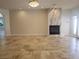 Bright living room features tile floors and a stylish fireplace, with a doorway leading to other rooms at 7261 Obannon Dr, Las Vegas, NV 89117