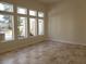 Bright living room boasts large windows and travertine tile flooring at 7261 Obannon Dr, Las Vegas, NV 89117