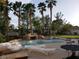 Outdoor patio area near the pool and mature tropical landscaping at 7261 Obannon Dr, Las Vegas, NV 89117