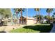 Exterior view of the pool area surrounded by palm trees and well-maintained landscaping at 8000 Badura Ave # 1020, Las Vegas, NV 89113