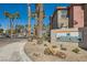 Exterior view of the Serenade Palms Condominium Homes signage surrounded by palm trees and desert landscaping at 8000 Badura Ave # 1020, Las Vegas, NV 89113