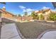 Landscaped backyard with gravel and patio, offering low maintenance and plenty of room to relax at 8304 Esmont Ln, Las Vegas, NV 89117