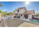 Charming backyard showcasing the house, pool, patio, and low-maintenance gravel landscaping at 8304 Esmont Ln, Las Vegas, NV 89117