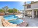 This backyard oasis features a luxurious pool and spa with a covered patio for outdoor entertaining at 8304 Esmont Ln, Las Vegas, NV 89117