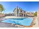 Backyard view of a large swimming pool, patio area, and the back of a two-story home at 8304 Esmont Ln, Las Vegas, NV 89117
