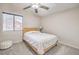 Bedroom features a ceiling fan, bright window, and carpet floors at 8304 Esmont Ln, Las Vegas, NV 89117