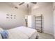 Bright bedroom features neutral walls, a ceiling fan, and a view to the home's hallway at 8304 Esmont Ln, Las Vegas, NV 89117