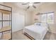 Bedroom features shelving unit, closet with mirrored sliding doors, ceiling fan, and a window at 8304 Esmont Ln, Las Vegas, NV 89117