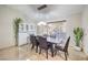 Contemporary dining area featuring a stylish light fixture, modern table, and an elegant white cabinet at 8304 Esmont Ln, Las Vegas, NV 89117