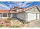 Charming two-story home with a three-car garage, desert landscaping, and a red tile roof at 8304 Esmont Ln, Las Vegas, NV 89117