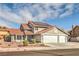 Two-story home featuring a red tile roof, three-car garage, desert landscaping, and solar panels at 8304 Esmont Ln, Las Vegas, NV 89117