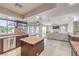 View of the kitchen and open living space with a fireplace, seamlessly connected at 8304 Esmont Ln, Las Vegas, NV 89117