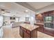 A kitchen island that opens to living room, and double wall oven at 8304 Esmont Ln, Las Vegas, NV 89117