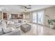 Open-concept living room with tile flooring and a seamless transition to a modern kitchen at 8304 Esmont Ln, Las Vegas, NV 89117