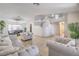 Spacious living room featuring tile floors, staircase, and large windows for ample natural light at 8304 Esmont Ln, Las Vegas, NV 89117