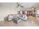 Spacious living area featuring a large sectional sofa and tile flooring at 8304 Esmont Ln, Las Vegas, NV 89117