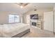 Bright main bedroom features a fireplace, ceiling fan, and ensuite bathroom at 8304 Esmont Ln, Las Vegas, NV 89117