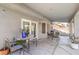 Covered patio with tables and chairs, offering the perfect spot for relaxation and outdoor dining at 8304 Esmont Ln, Las Vegas, NV 89117