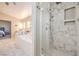 Bathroom shower boasts marble tiling, rainfall showerhead and built-in niche at 8304 Esmont Ln, Las Vegas, NV 89117