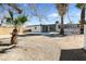 Large backyard featuring desert landscaping, mature trees, and a concrete patio perfect for outdoor entertaining at 909 Hazard Ave, Las Vegas, NV 89108