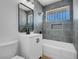 Modern bathroom with gray tile, sleek vanity, and a shower over tub combination at 909 Hazard Ave, Las Vegas, NV 89108