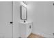 Bathroom vanity features a modern black faucet, mirror, and white shaker cabinets at 909 Hazard Ave, Las Vegas, NV 89108