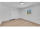 A bedroom with light hardwood floors and a window at 909 Hazard Ave, Las Vegas, NV 89108