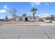 Charming single-story home featuring a well-maintained yard, a long driveway and mature palm trees at 909 Hazard Ave, Las Vegas, NV 89108