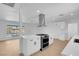 Bright and airy kitchen featuring stainless steel appliances and modern range hood at 909 Hazard Ave, Las Vegas, NV 89108