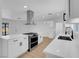 Bright kitchen with stainless steel appliances, white cabinets, and modern range hood at 909 Hazard Ave, Las Vegas, NV 89108