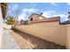 Narrow backyard space features low-maintenance gravel landscaping and a secure perimeter fence at 9119 Brilliant Prairie Ct, Las Vegas, NV 89149