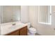 Bathroom features a single sink vanity with a white countertop and wood cabinets at 9119 Brilliant Prairie Ct, Las Vegas, NV 89149