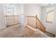 View of the second floor landing with carpet floors and wood banister at 9119 Brilliant Prairie Ct, Las Vegas, NV 89149