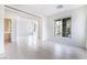 Bright living room featuring tile floors, neutral walls and arched windows at 9119 Brilliant Prairie Ct, Las Vegas, NV 89149