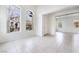 Bright living room featuring tile floors, neutral walls and arched windows at 9119 Brilliant Prairie Ct, Las Vegas, NV 89149
