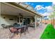 Large backyard patio with pergola, outdoor dining, and green space at 9675 Bold Skye Ave, Las Vegas, NV 89166