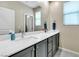 Well-lit bathroom featuring a dual sink vanity with modern fixtures and a large mirror at 9675 Bold Skye Ave, Las Vegas, NV 89166