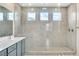 Bright bathroom showcasing a spacious walk-in shower with multiple showerheads and glass enclosure at 9675 Bold Skye Ave, Las Vegas, NV 89166