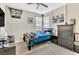 This bedroom has a TV, full bed, and dresser at 9675 Bold Skye Ave, Las Vegas, NV 89166