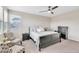 Bright bedroom featuring a bed, dresser, two chairs, and a side table at 9675 Bold Skye Ave, Las Vegas, NV 89166