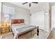 Bedroom with large window, neutral walls, and ceiling fan at 9675 Bold Skye Ave, Las Vegas, NV 89166