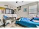 The bedroom has a full bed, a TV, and window with blinds at 9675 Bold Skye Ave, Las Vegas, NV 89166