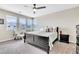 Well-lit bedroom featuring a bed, bay windows, and a sitting area at 9675 Bold Skye Ave, Las Vegas, NV 89166