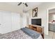 Cozy bedroom featuring a ceiling fan, TV atop a wooden cabinet, and a comfortable bed at 9675 Bold Skye Ave, Las Vegas, NV 89166
