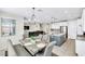 Dining room with stylish chandelier, large window and a view of the kitchen at 9675 Bold Skye Ave, Las Vegas, NV 89166