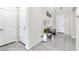 Bright entryway with neutral walls, tiled floor, bench, and decorative accents at 9675 Bold Skye Ave, Las Vegas, NV 89166