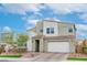 Modern two-story home features a two-car garage, desert landscaping, and tile roof at 9675 Bold Skye Ave, Las Vegas, NV 89166